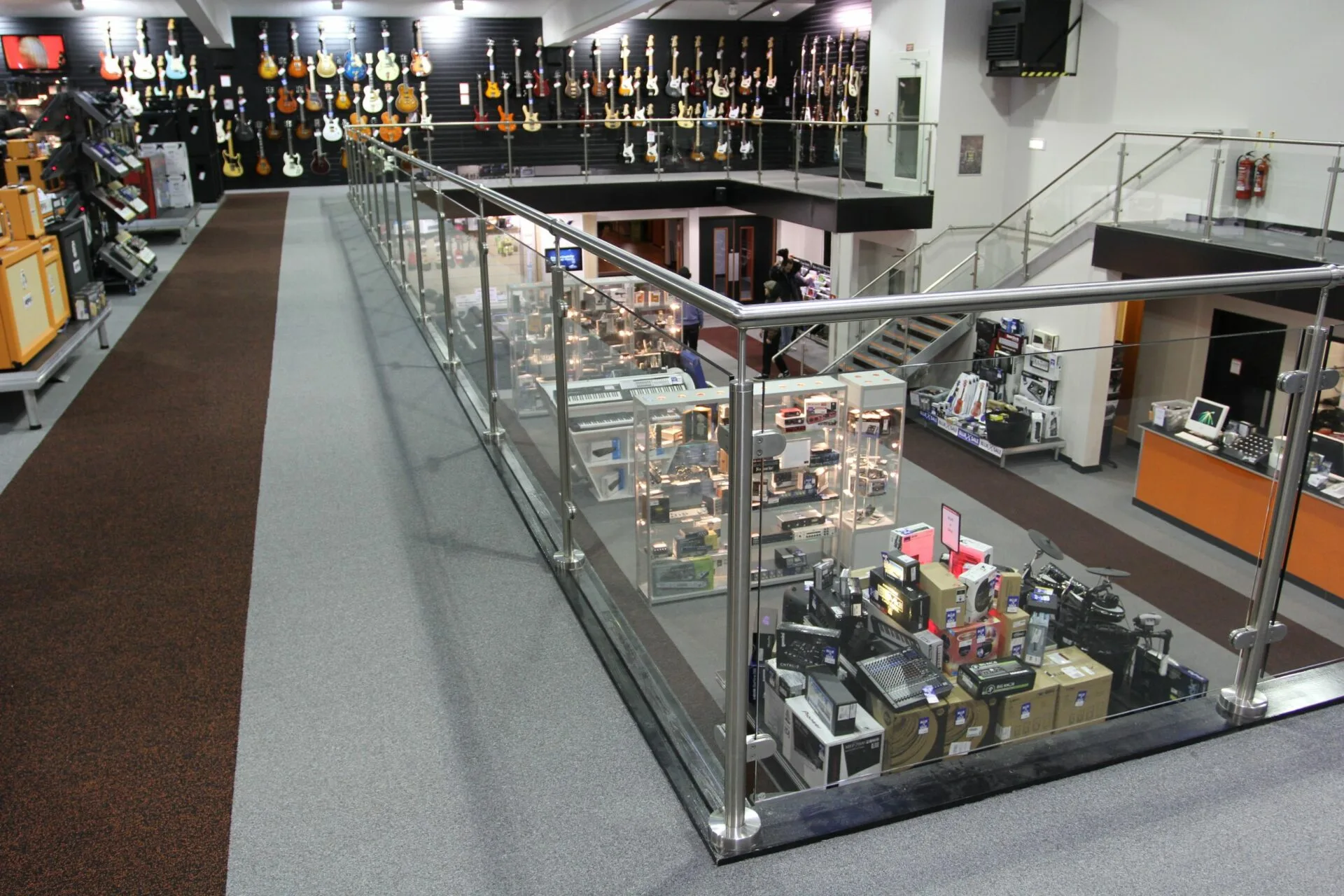 glass handrail on mezzanine floor in showroom