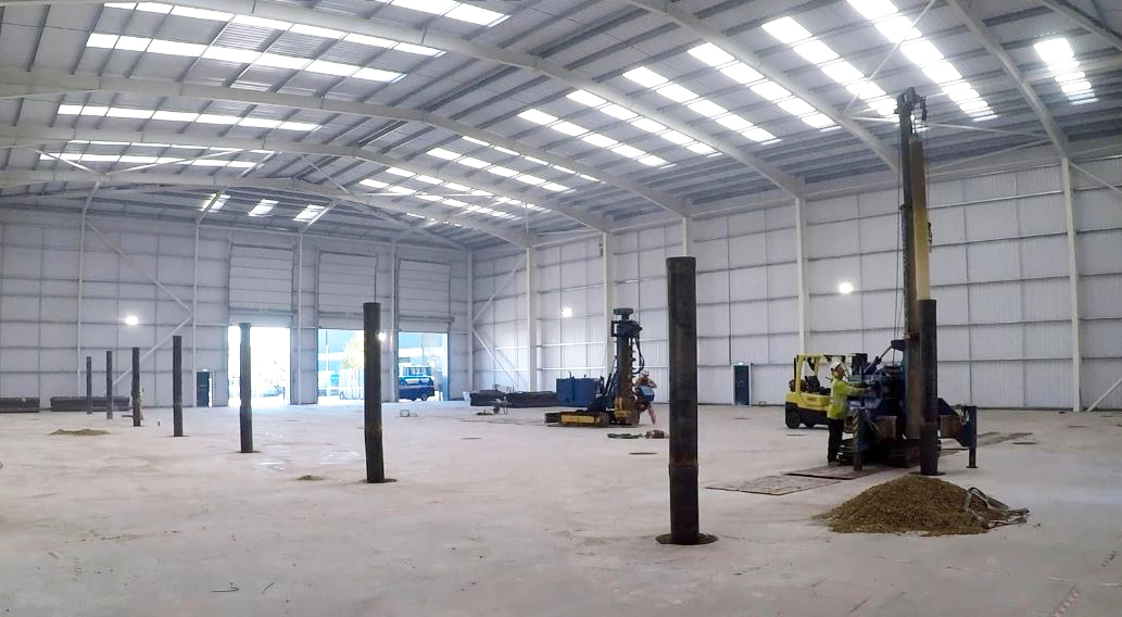 ground slab piling works being completed in warehouse