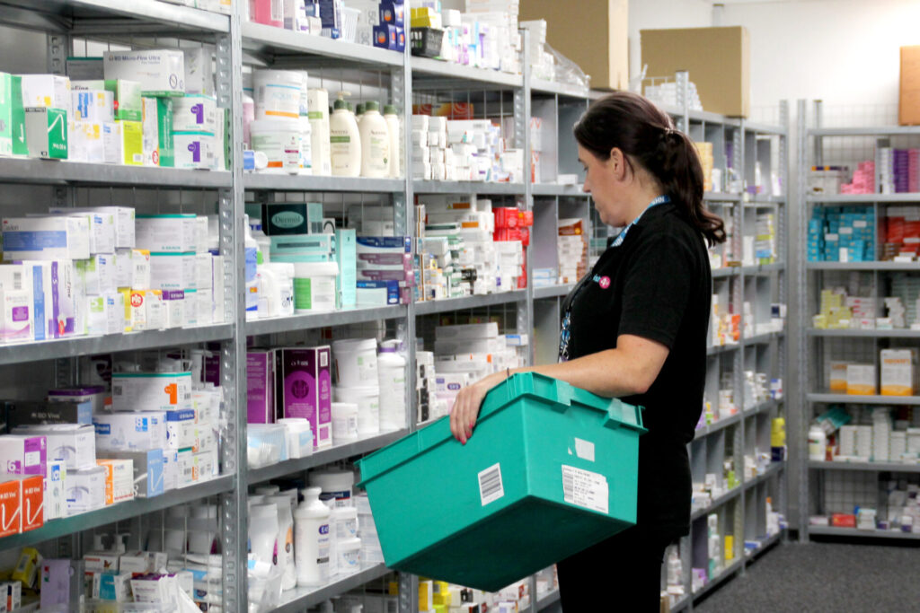 chemist 4 U staff picking medicine order from shelving