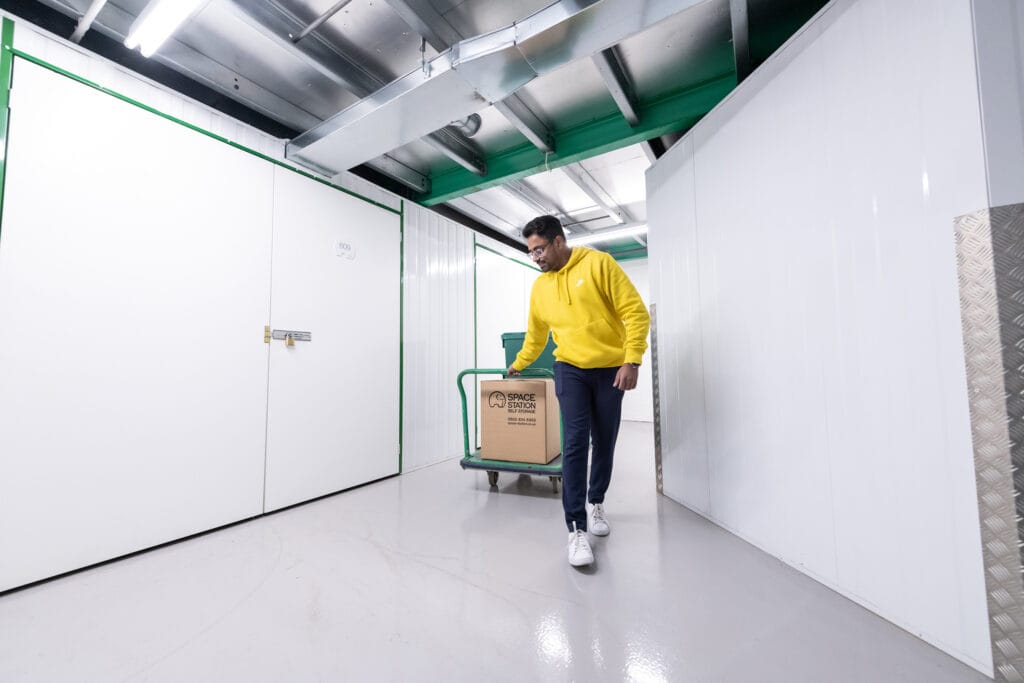 space station self storage customer with boxes on trolley